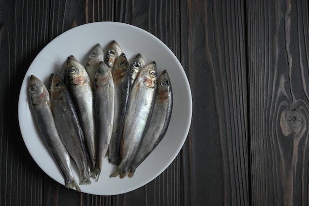 Fresh sardines on rustic wooden background