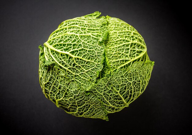 Fresh savoy cabbage isolated on a black background