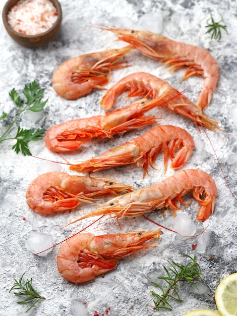 Fresh shrimps on ice and gray background