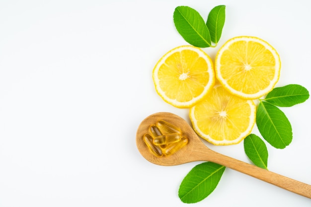 Fresh slice lemon with leaves, vitamin c capsule supplement from natural isolated on white background 