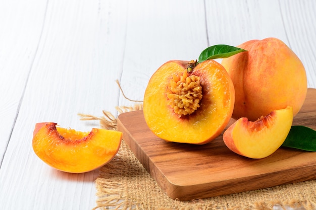 Fresh sliced peach on a wooden board