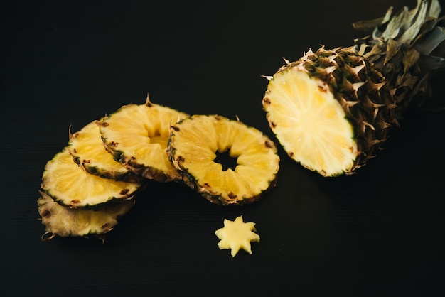 Fresh sliced pineapple on a dark background