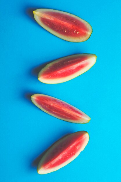 Fresh sliced watermelon on a bright blue background