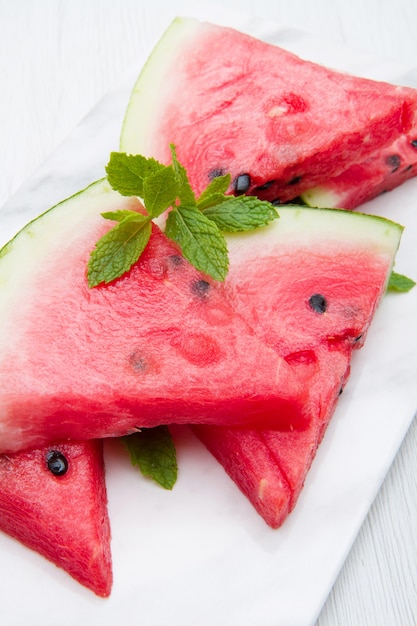 Fresh sliced watermelon on wood bowl