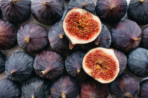 Fresh sliced and whole ripe figs on white background. Food photo background. Flat lay, Top view.