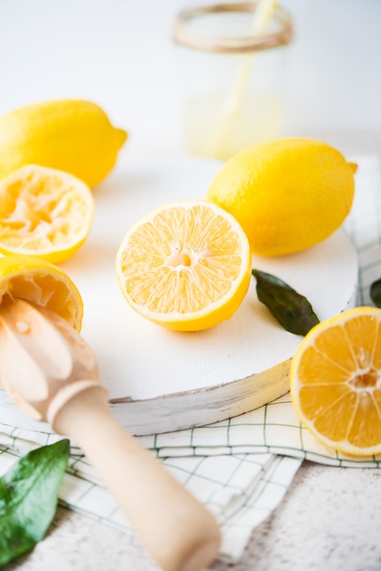 Fresh sliced yellow lemons on a white background, selective focus