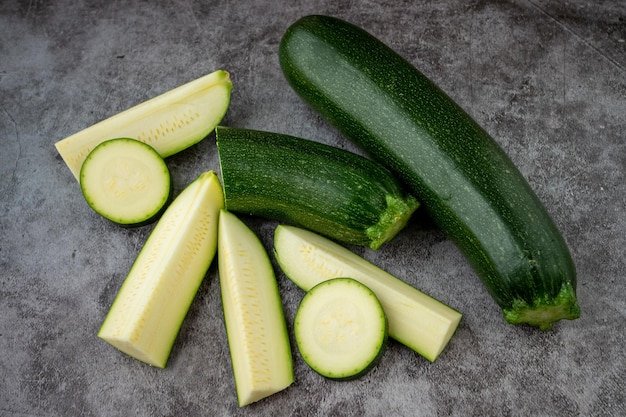 Fresh sliced zucchini on a black background