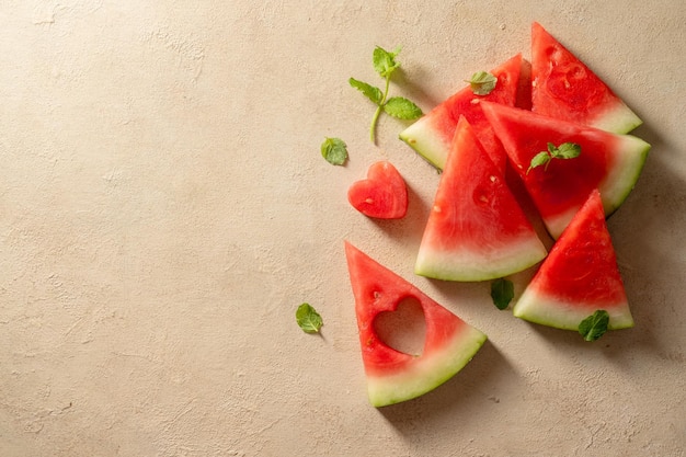 Fresh slices of watermelon over warm neutral background Summer abstract texture Copy space