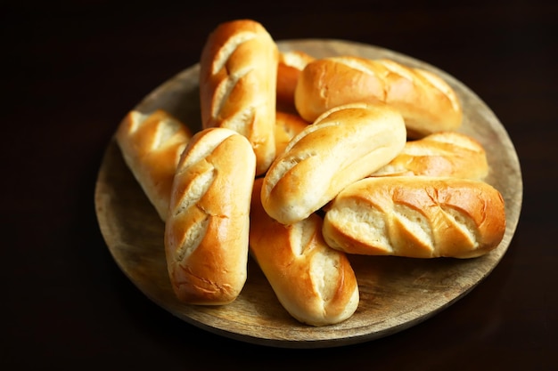 Fresh small buns on a wooden tray