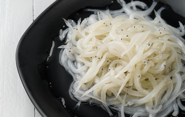 Fresh small whitebait on a monochrome background