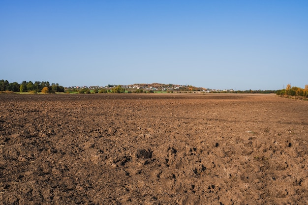 Fresh soil, arable land and blue sky