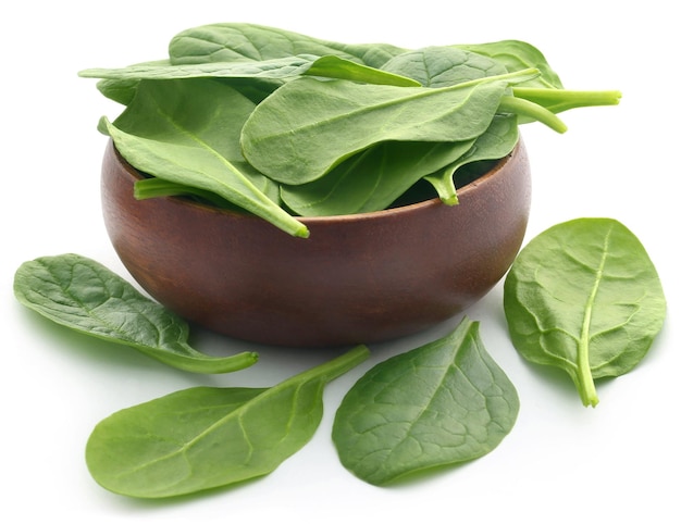 Fresh Spinach in a bowl over white background