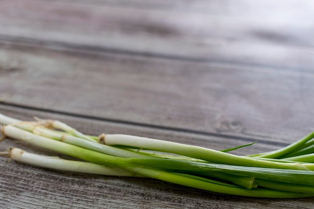 Fresh spring green onion on wooden background