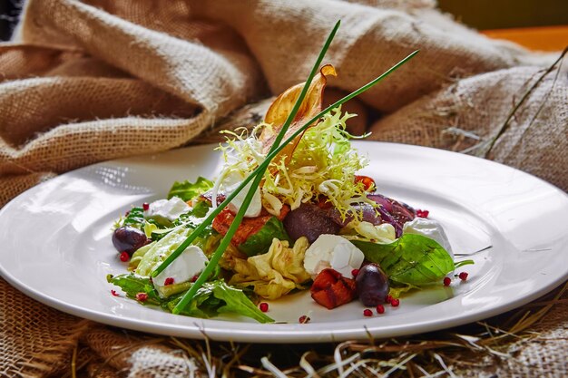 Fresh spring salad with feta cheese red onion in white bowl