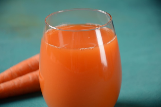 Fresh squeezed carrot juice in a Glass with carrots on a table Healthy eating detox dieting and vegetarian concept