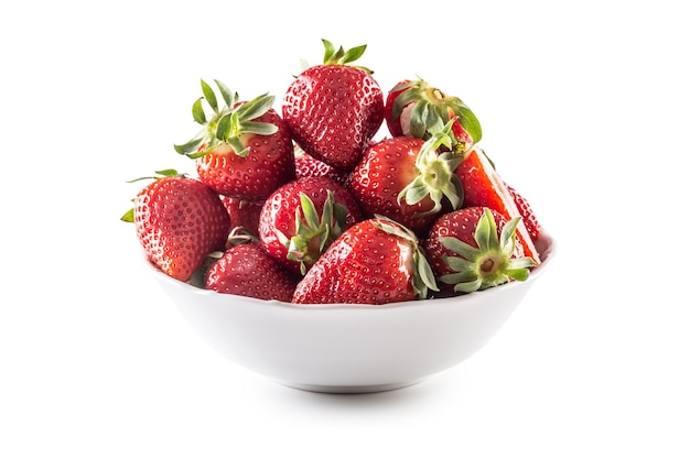 Fresh strawberries in a bowl on a white isolated background