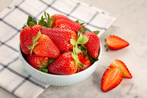 Fresh strawberries in ceramic bowl