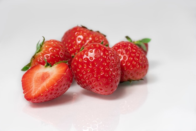 Fresh strawberries closeup in a cut on a white background