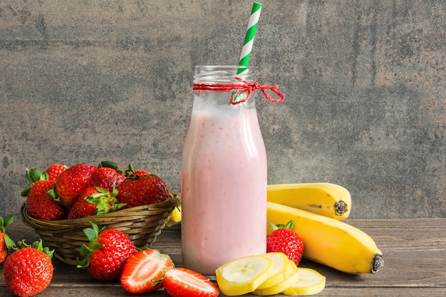 Fresh strawberry and banana smoothie in a bottle