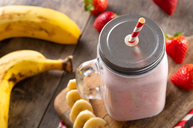 Fresh strawberry and banana smoothie in jar