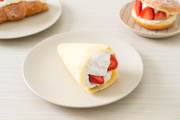 fresh strawberry and fresh cream crepe on plate