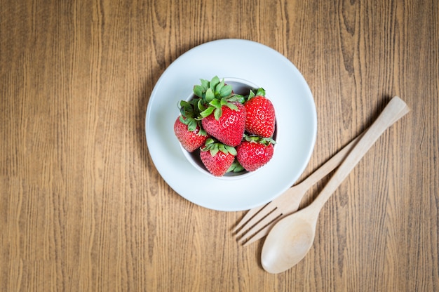 Fresh strawberry and juice on wood table. flat lay.