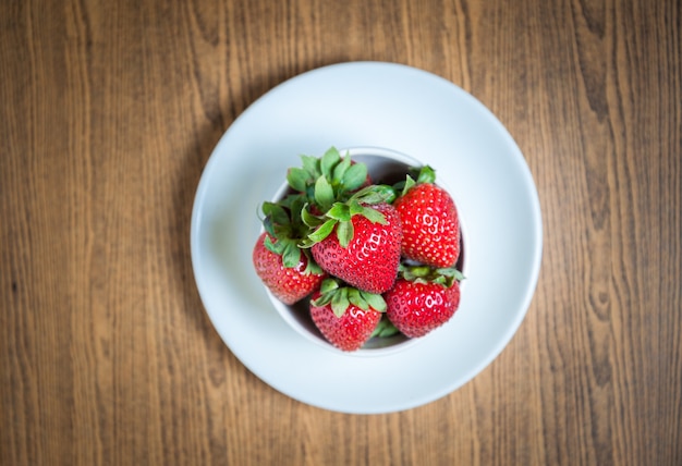 Fresh strawberry and juice on wood table. flat lay.