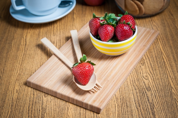 Fresh strawberry and juice on wood table. 