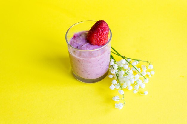 Fresh strawberry smoothie on a yellow background Lilies and Berry Smoothies lily of the valley