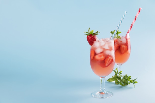 Fresh strawberry summer cocktails and ice cubes