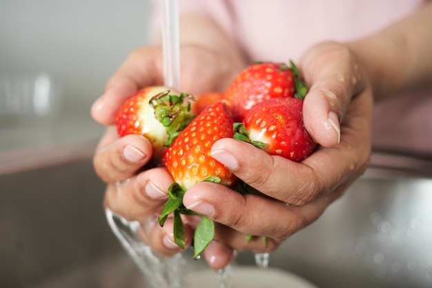 Fresh strawberry washing with hand