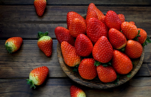 Fresh Strawberry in wooden  plate on wooden background