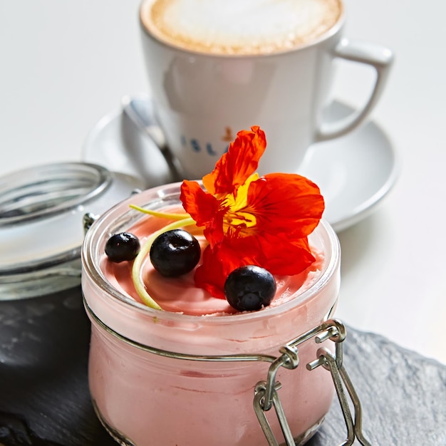 Fresh strawberry yoghurt dessert in glass selective focus