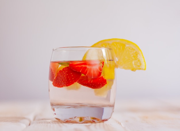 Fresh summer cocktail of strawberry and lemon close-up. a glass of homemade refreshing drink