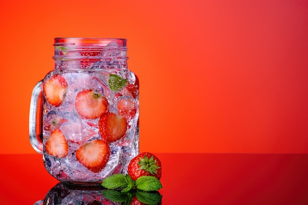 Fresh summer cocktail with strawberry and ice cubes