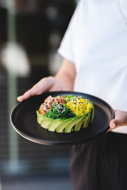 Fresh summer dish with vegetables and salmon topped with sesame seeds. Healthy lifestyle