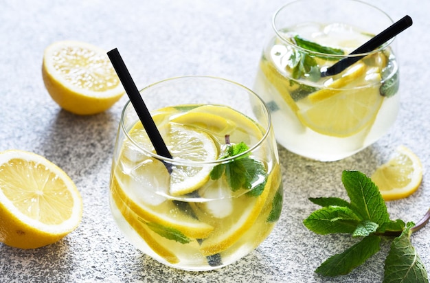 Fresh summer drink Cold lemonade with mint on a concrete background