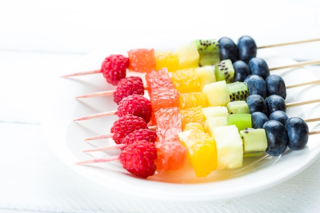 Fresh summer fruits on sticks Studio shot