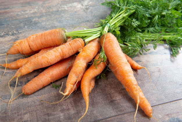 Fresh and sweet carrot on wooden background