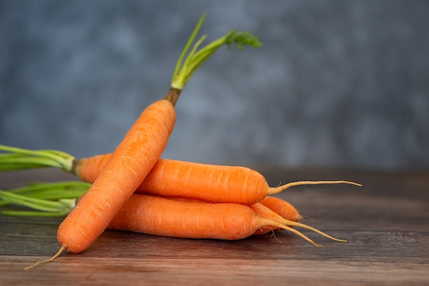 Fresh and sweet carrot on a wooden table.