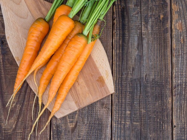 Fresh and sweet carrots on an old wooden table