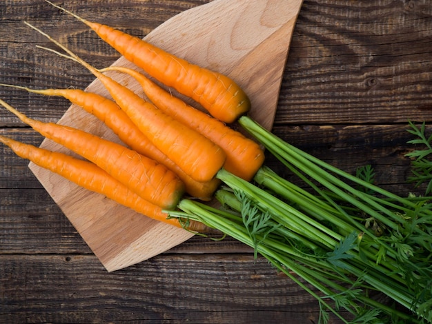 Fresh and sweet carrots on an old wooden table