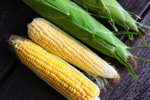 fresh sweet corn on wooden table