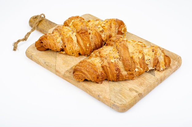 Fresh sweet croissants for breakfast on white. Studio Photo