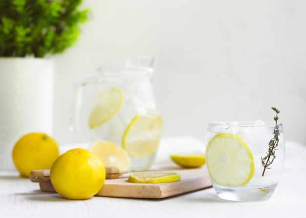 Fresh Sweet Lemonade Water; knife, wood and some plants