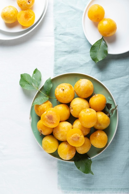 Fresh sweet yellow plums on the table