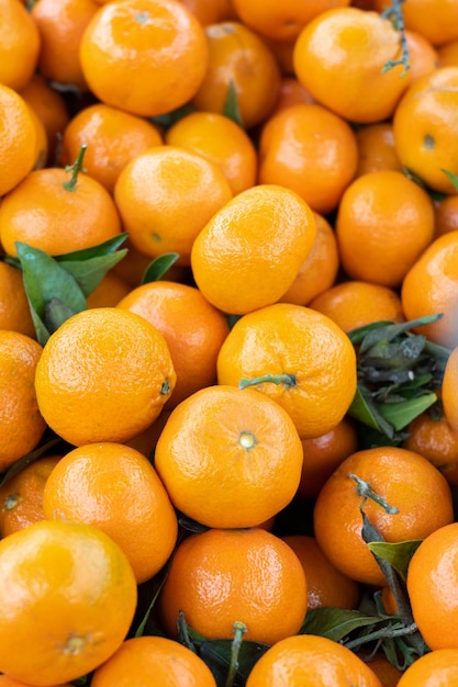 Fresh tangerines or mandarin oranges fruit with leaves citrus background