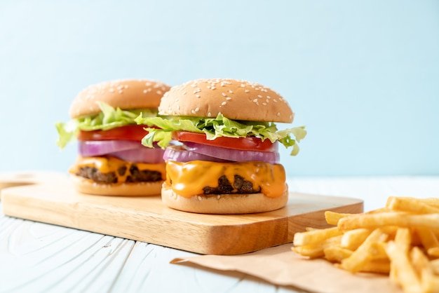 fresh tasty beef burger with cheese and french fries