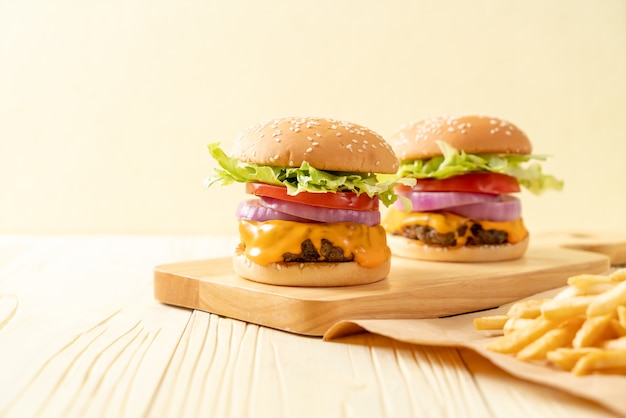 fresh tasty beef burger with cheese and french fries