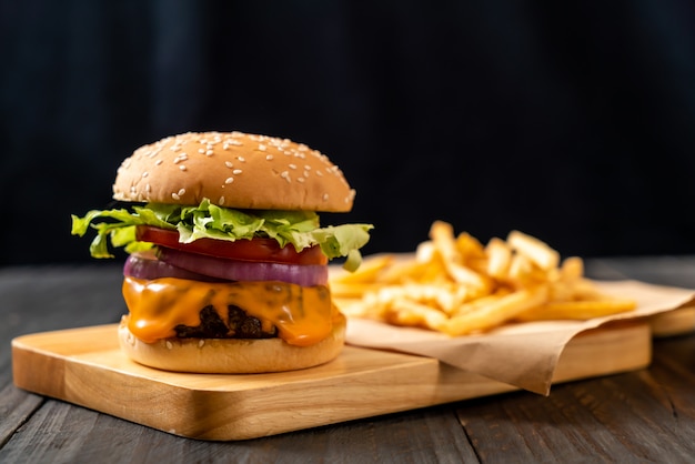 fresh tasty beef burger with cheese and french fries